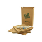 Various sizes of used moving and storage boxes shown flattened, along with included supplies, in a Studio or Dorm Room Moving Kit (SUPER) by UsedCardboardBoxes.